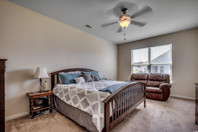 bedroom with ceiling fan and light carpet