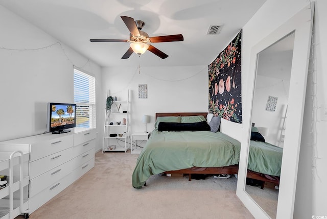 bedroom with light colored carpet and ceiling fan