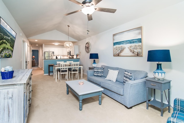 carpeted living room with ceiling fan and vaulted ceiling