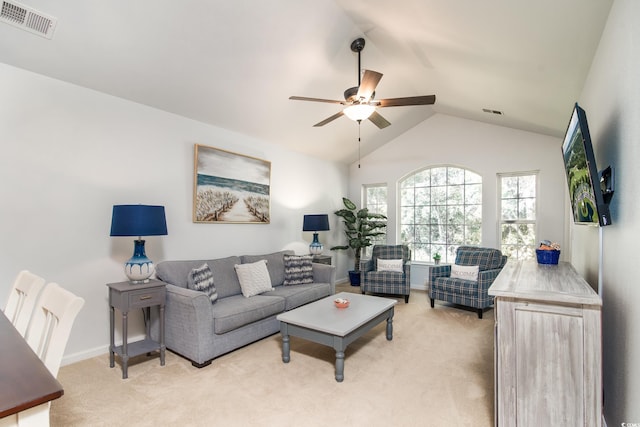 carpeted living room with ceiling fan and lofted ceiling