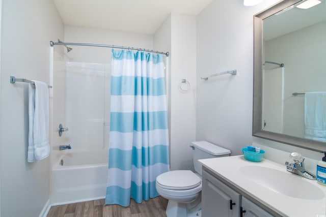 full bathroom featuring hardwood / wood-style flooring, vanity, toilet, and shower / tub combo