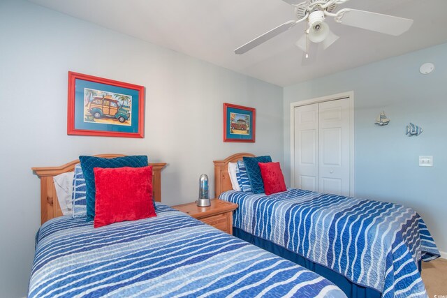 bedroom with carpet, ceiling fan, and a closet