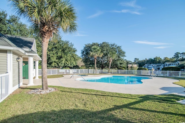 view of pool with a patio area and a lawn