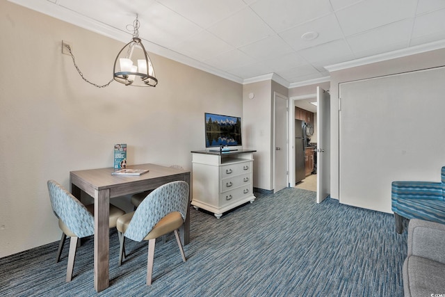 carpeted dining space featuring crown molding