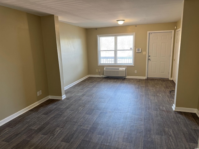 entrance foyer with dark hardwood / wood-style floors and a wall unit AC