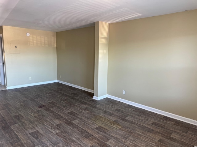 spare room featuring dark wood-type flooring