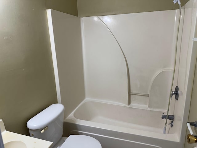 full bathroom featuring washtub / shower combination, vanity, and toilet