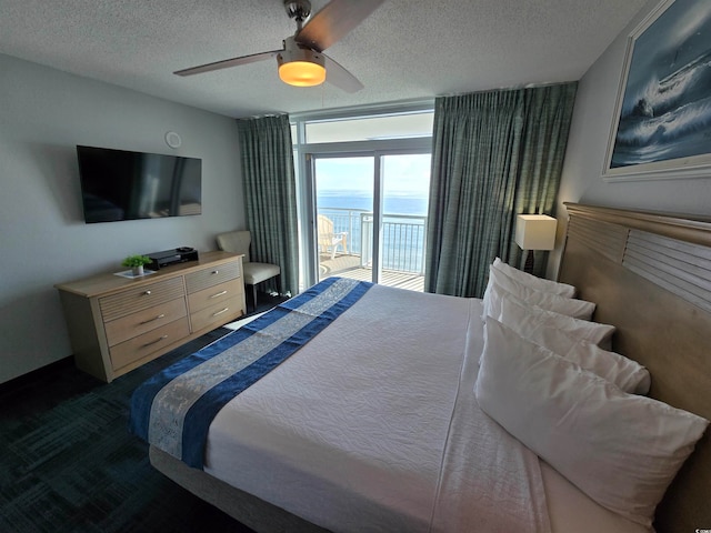 carpeted bedroom featuring access to exterior, ceiling fan, and a textured ceiling