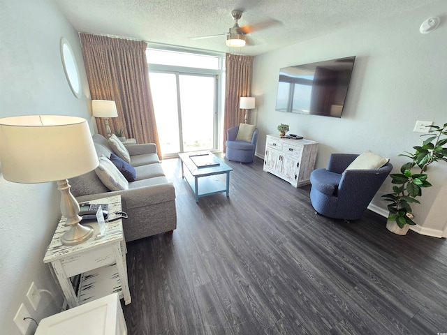 living room with a textured ceiling, ceiling fan, and dark hardwood / wood-style floors