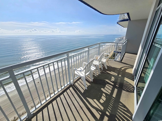 balcony with a water view and a beach view