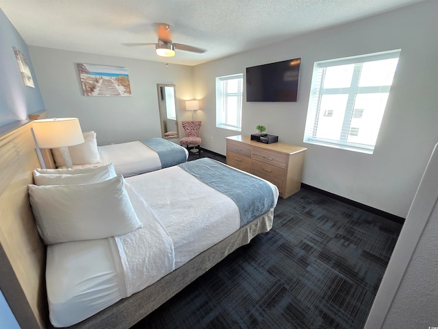 bedroom with ceiling fan and a textured ceiling