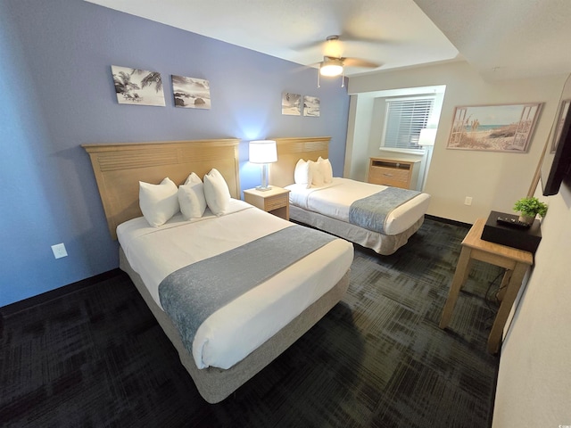 carpeted bedroom with a wall unit AC and ceiling fan