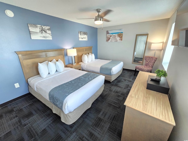 bedroom featuring dark carpet and ceiling fan