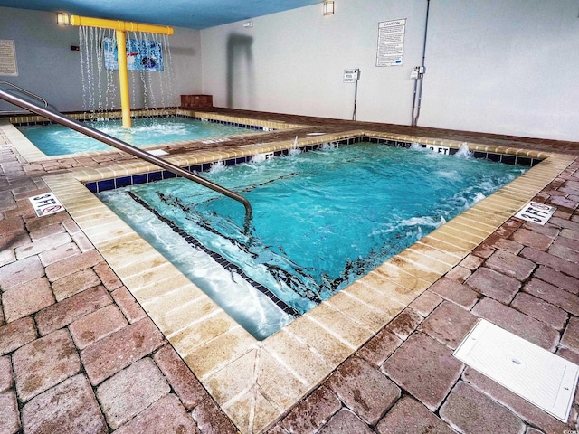 view of swimming pool with an indoor in ground hot tub