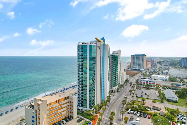 birds eye view of property with a water view and a view of the beach