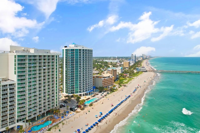 aerial view with a water view and a beach view