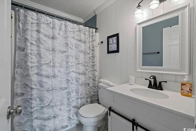 bathroom featuring crown molding, vanity, a textured ceiling, and toilet