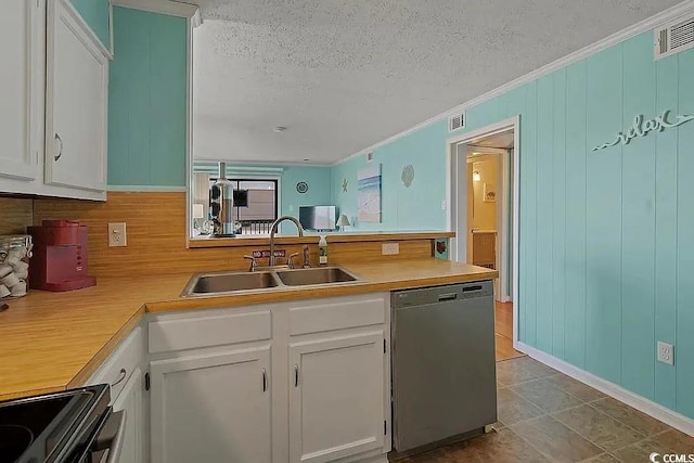 kitchen with white cabinets, sink, stainless steel dishwasher, electric range, and a textured ceiling