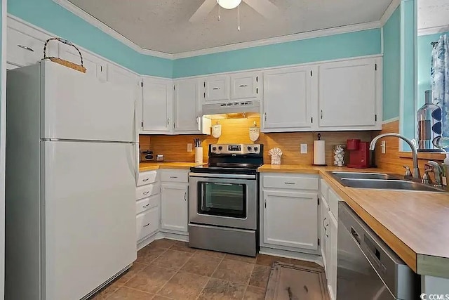 kitchen featuring ceiling fan, sink, stainless steel appliances, tasteful backsplash, and white cabinets