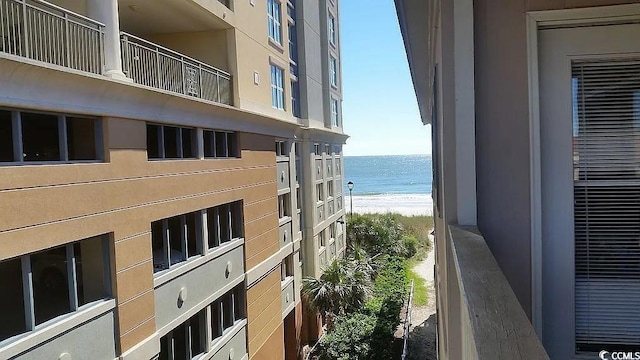 view of property featuring a water view and a beach view