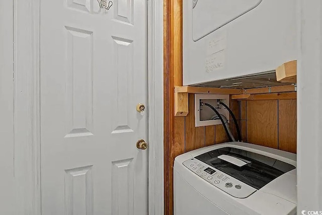 washroom featuring stacked washer / dryer