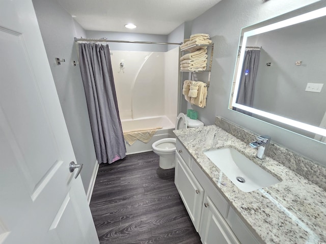 full bathroom with toilet, shower / bathtub combination with curtain, vanity, and hardwood / wood-style floors