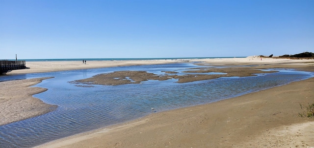 property view of water featuring a beach view