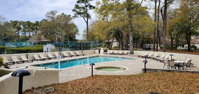 view of pool with a patio and a hot tub