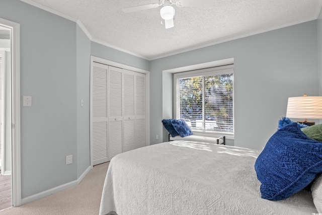 carpeted bedroom featuring a textured ceiling, a closet, and ceiling fan