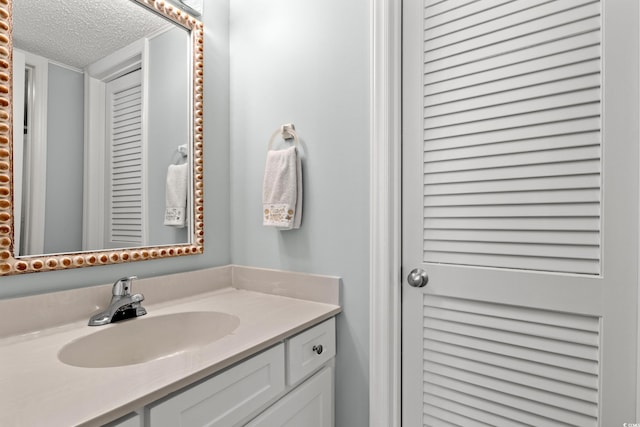 491 Ocean Creek Dr Unit 2614, Myrtle Beach, SC 29572 - bathroom with a textured ceiling and vanity