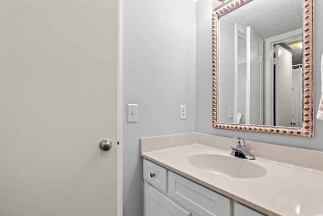 bathroom with vanity and a textured ceiling