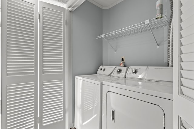 washroom featuring separate washer and dryer and ornamental molding