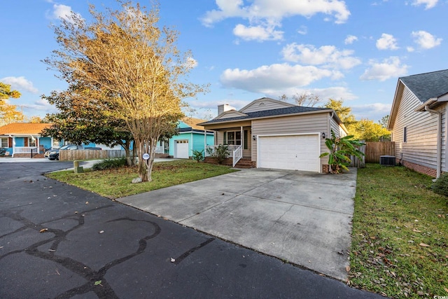 single story home featuring a front lawn and a garage