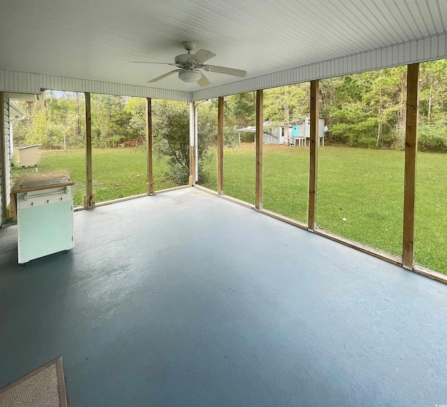 unfurnished sunroom featuring ceiling fan