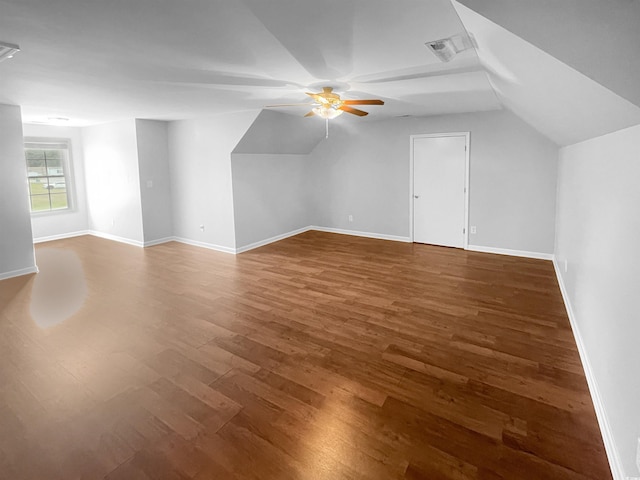 bonus room with ceiling fan, dark wood-type flooring, and lofted ceiling