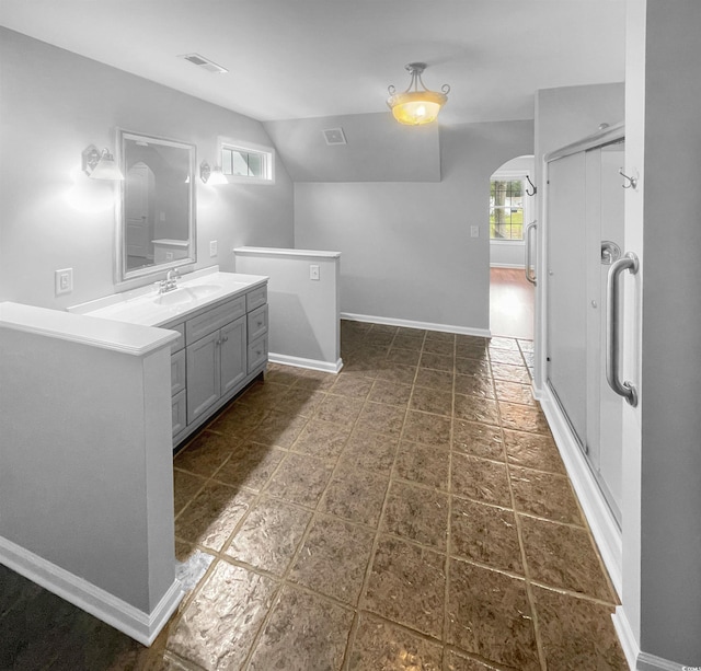 bathroom featuring vanity and vaulted ceiling