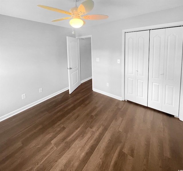 unfurnished bedroom with ceiling fan, dark hardwood / wood-style floors, and a closet