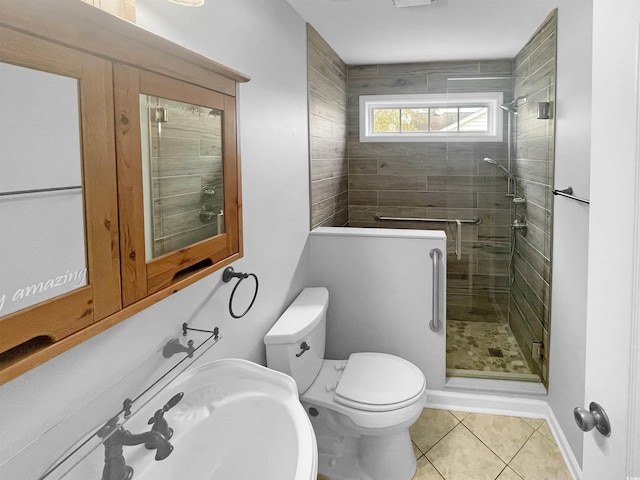 bathroom with tile patterned flooring, toilet, and an enclosed shower