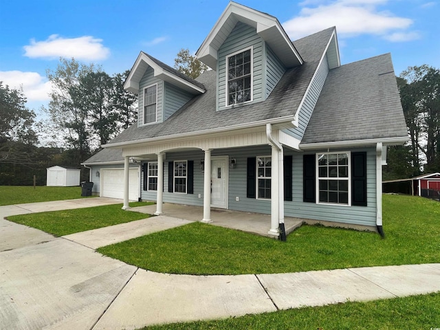 cape cod home with a shed, a front yard, a porch, and a garage