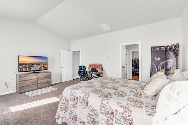 bedroom featuring a walk in closet, a closet, carpet, and vaulted ceiling