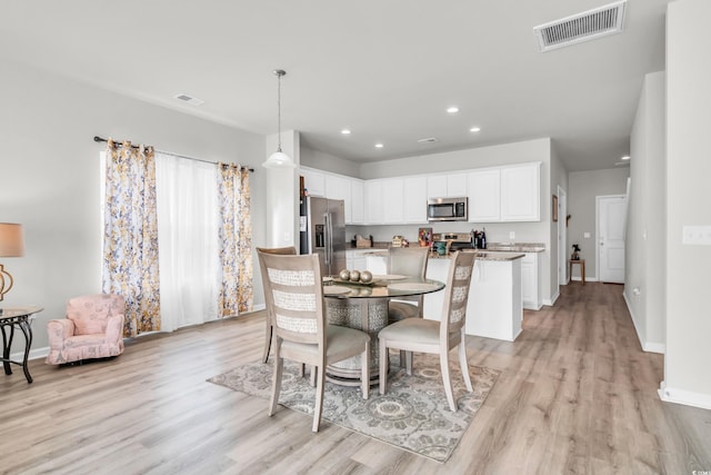 dining area with light wood-type flooring