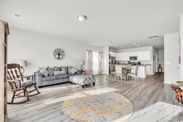 living room with light hardwood / wood-style flooring