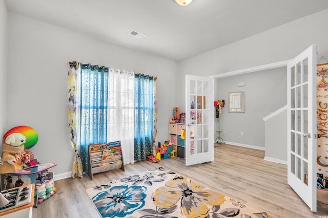 rec room with french doors and light hardwood / wood-style flooring