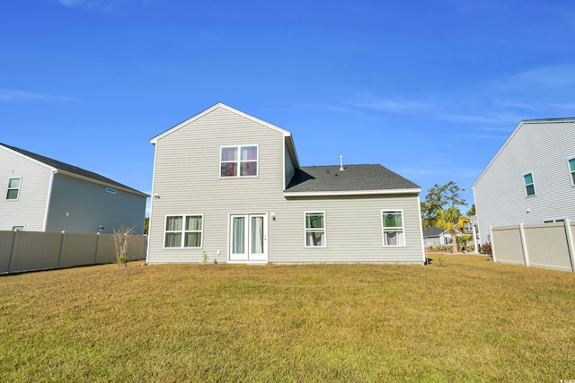 rear view of house with a lawn