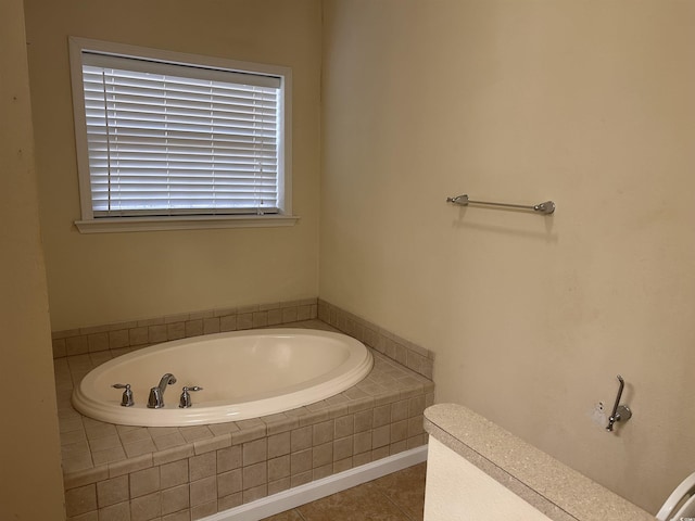 bathroom featuring tile patterned floors and tiled bath