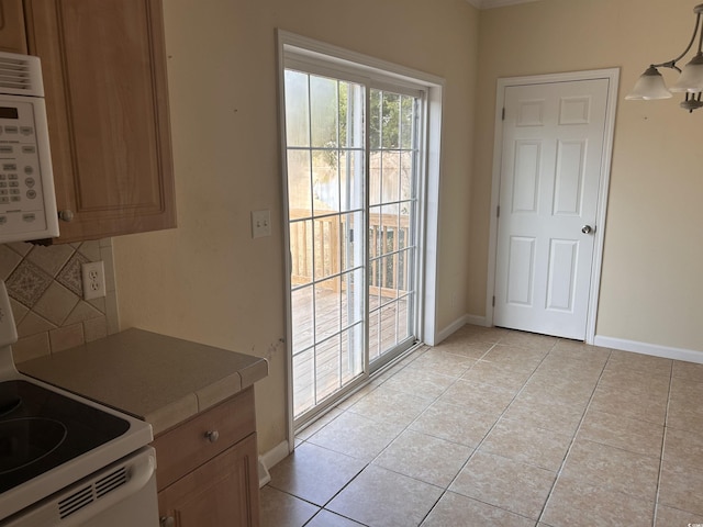 doorway to outside with light tile patterned flooring