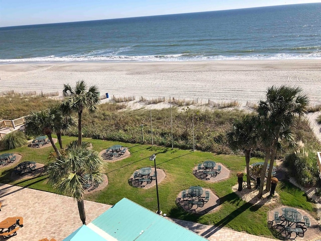 bird's eye view with a water view and a beach view