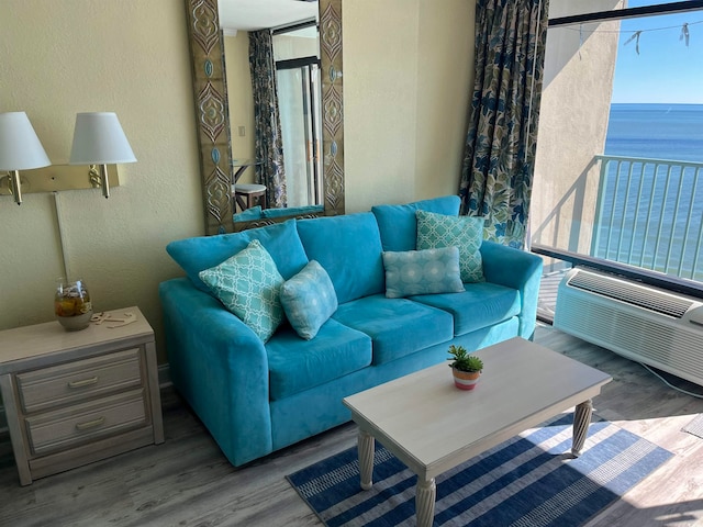 living room with a water view and light wood-type flooring