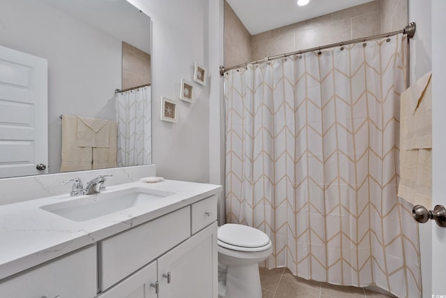 bathroom featuring tile patterned floors, walk in shower, vanity, and toilet