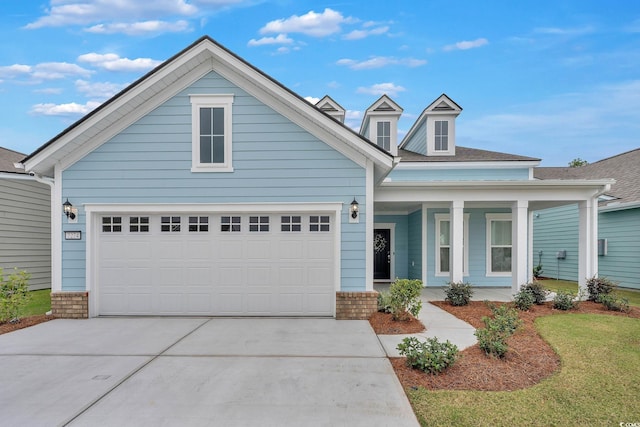 view of front of property with covered porch and a garage